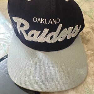 Oakland Raiders Spellout Mitchell & Ness Side Logo Hat Adjustable Snapback Cap